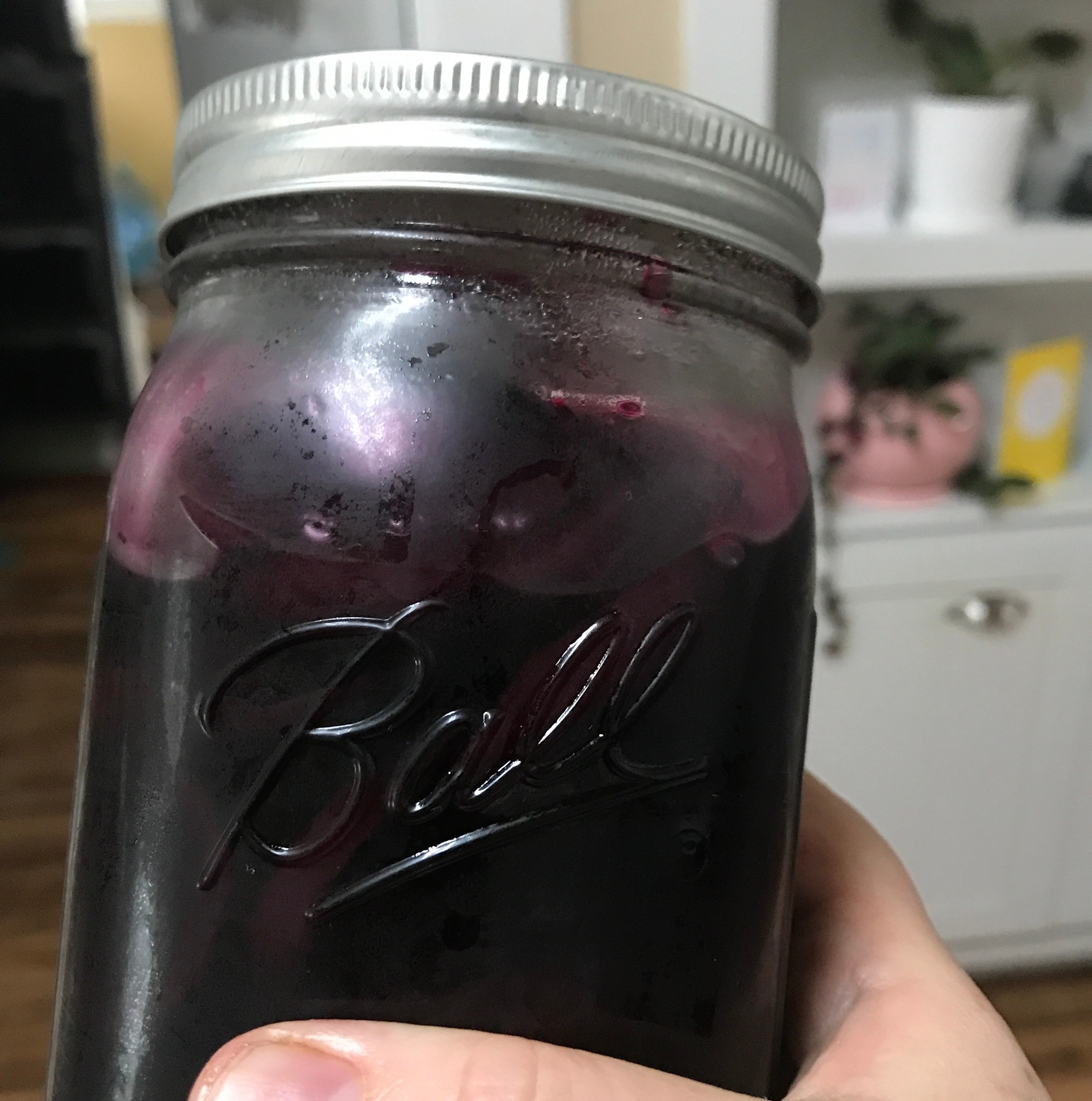 a glass quart jar of purple beets