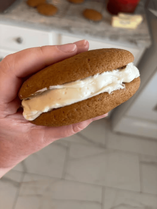 An oversized pumpkin whoopie pie with cream cheese filling